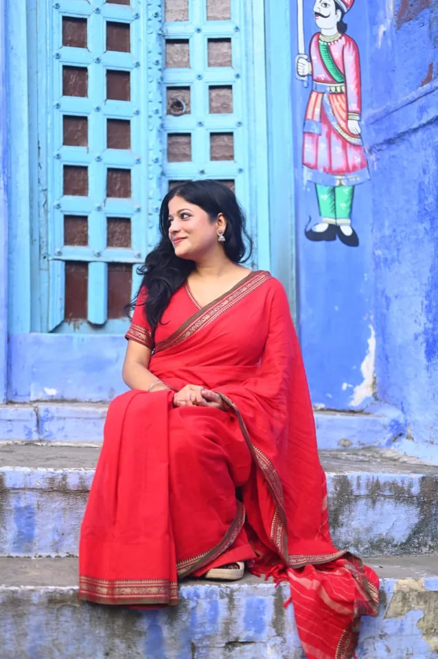 A traveller photographed against the painted walls of the lanes, photographed by One Moon Studio in Varanasi.