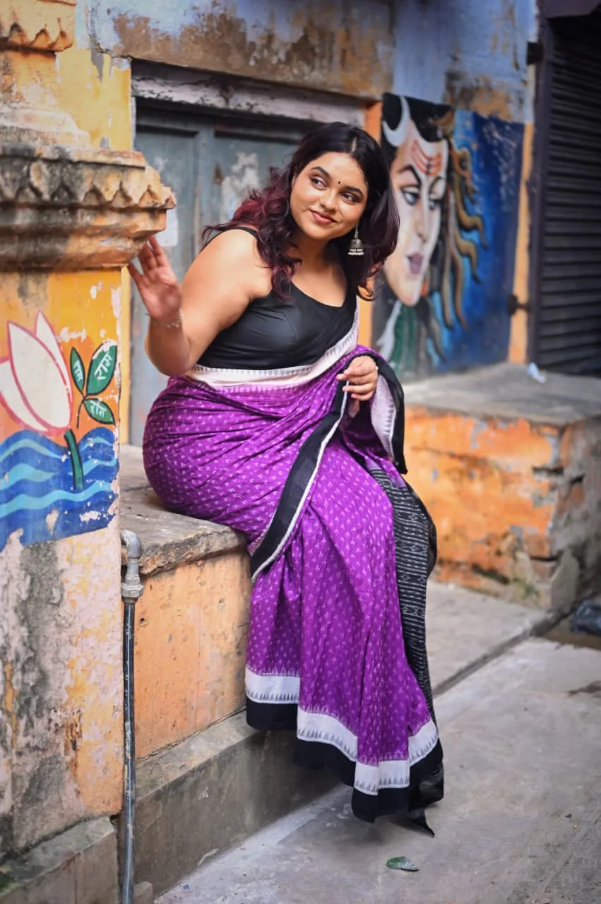 A traveller photographed candidly in the moving crowd of the old city, photographed by One Moon Studio in Varanasi.