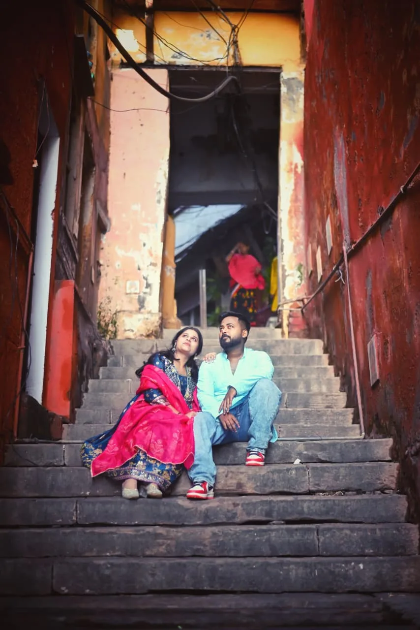 A couple on the ghats of Varanasi in the quiet of early morning, photographed by One Moon Studio in Varanasi.