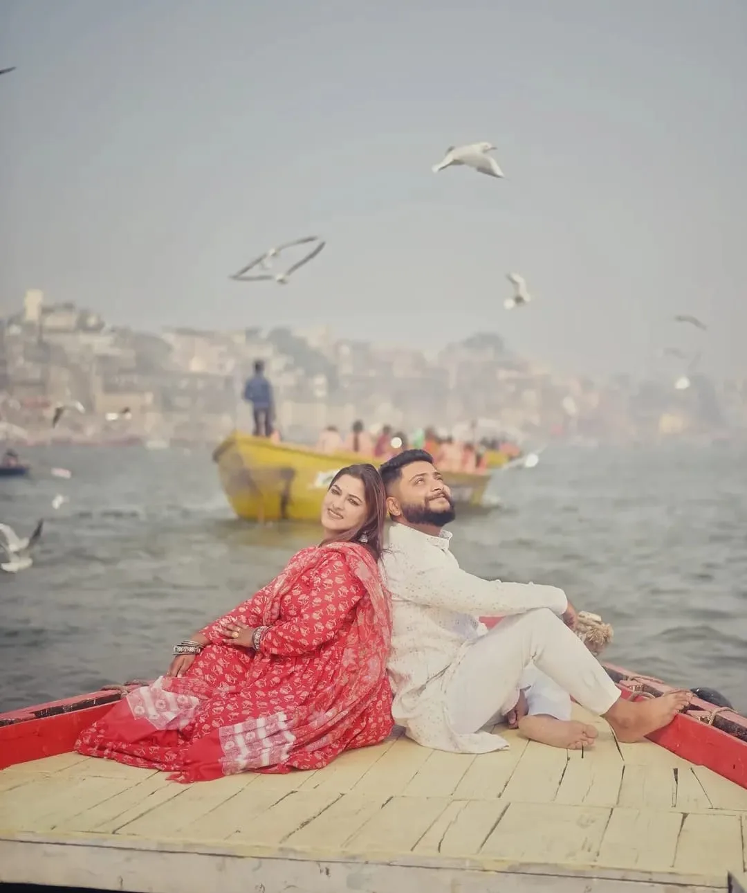 A pre-wedding frame on the Ganga, photographed from the water, photographed by One Moon Studio in Varanasi.
