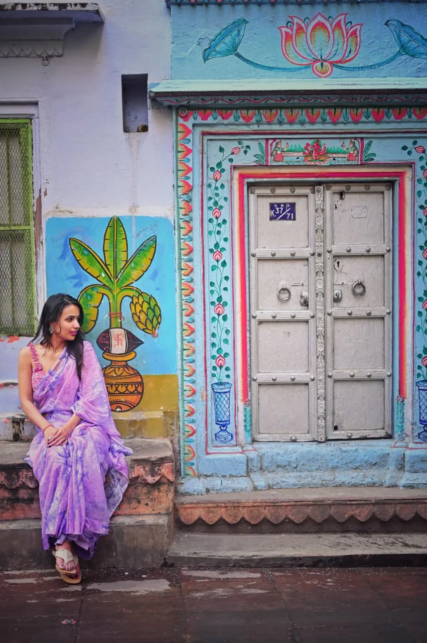 A solo traveller photographed in the old city of Varanasi, photographed by One Moon Studio in Varanasi.